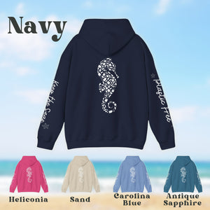 a navy hoodie with an image of a seahorse on it