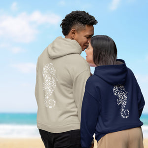 a man and a woman standing next to each other on a beach